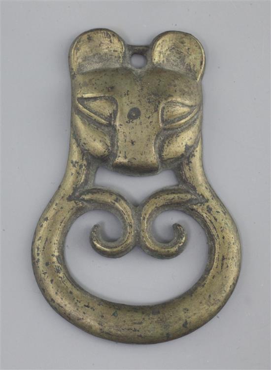 A Chinese archaic bronze tiger-mask harness plaque, probably Han dynasty, 2nd century B.C. - 2nd century A.D., 10.5cm